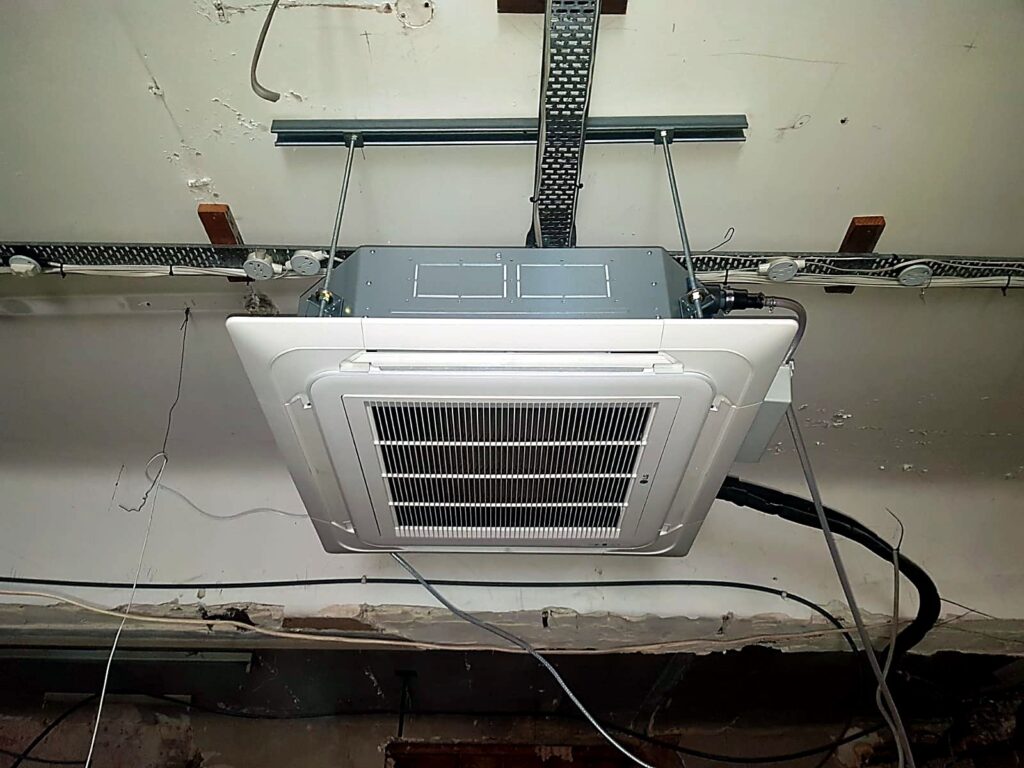 Ceiling cassette air conditioning unit being installed
