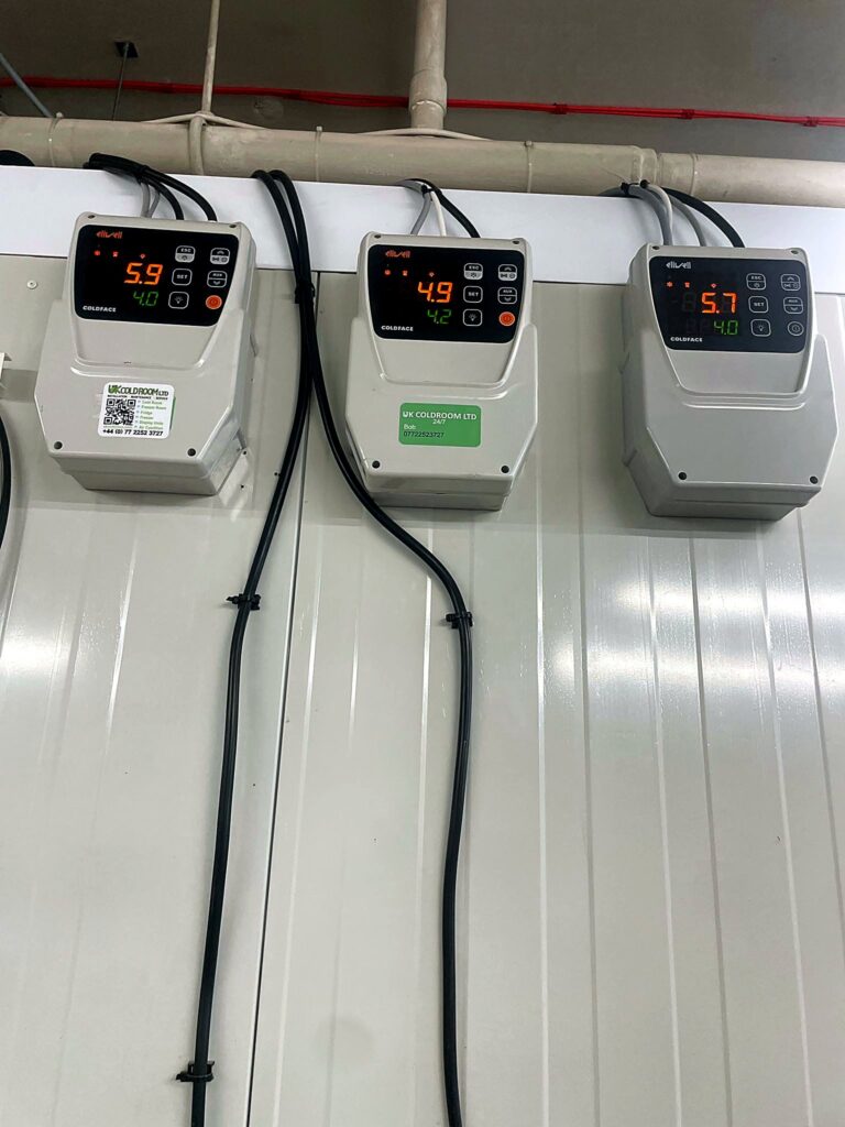 Three cold room controllers on a panel wall
