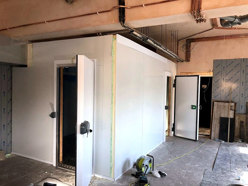 Cold room with door installed inside a commercial building