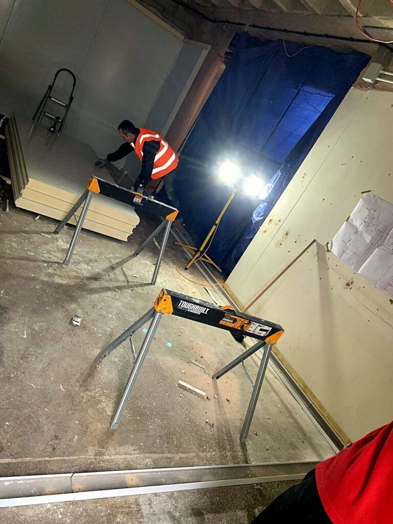 Engineer cutting cold room panels on site