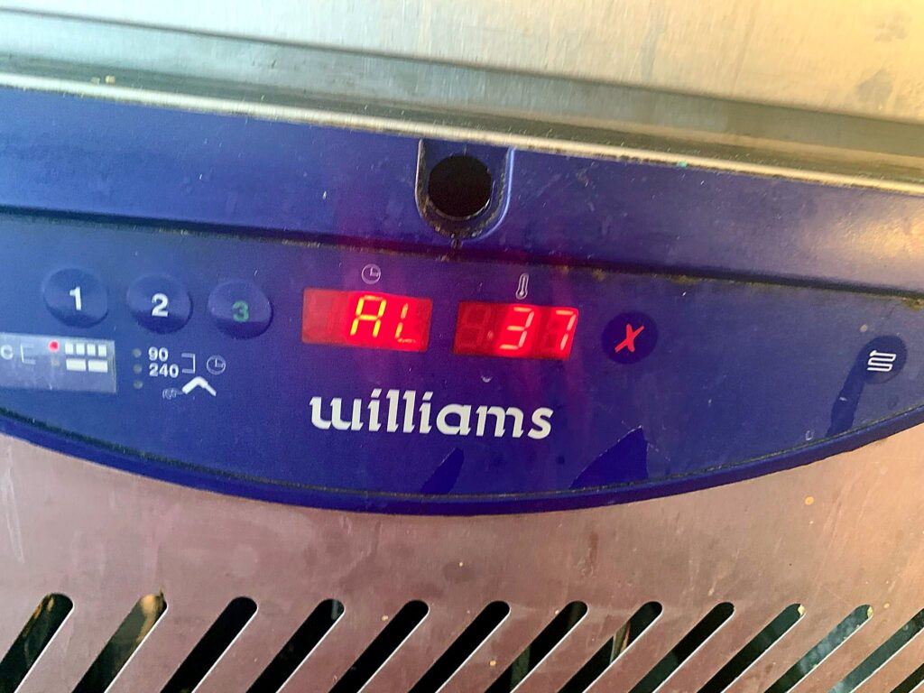 Refrigeration controller showing a fault alarm before repair