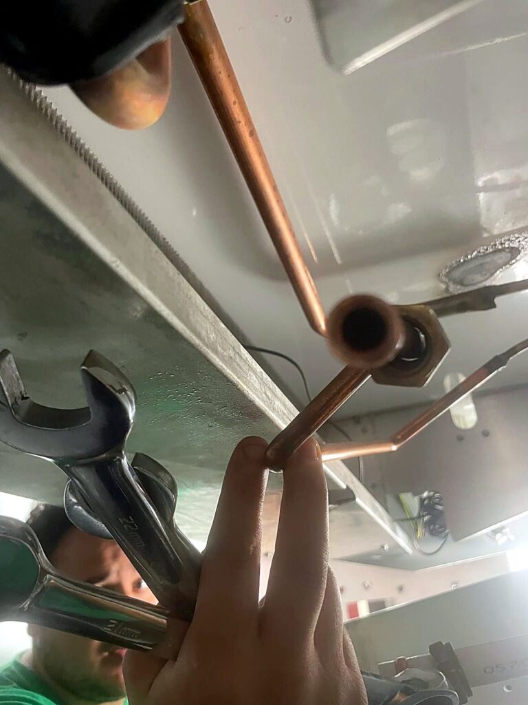 Engineer brazing copper refrigeration pipework