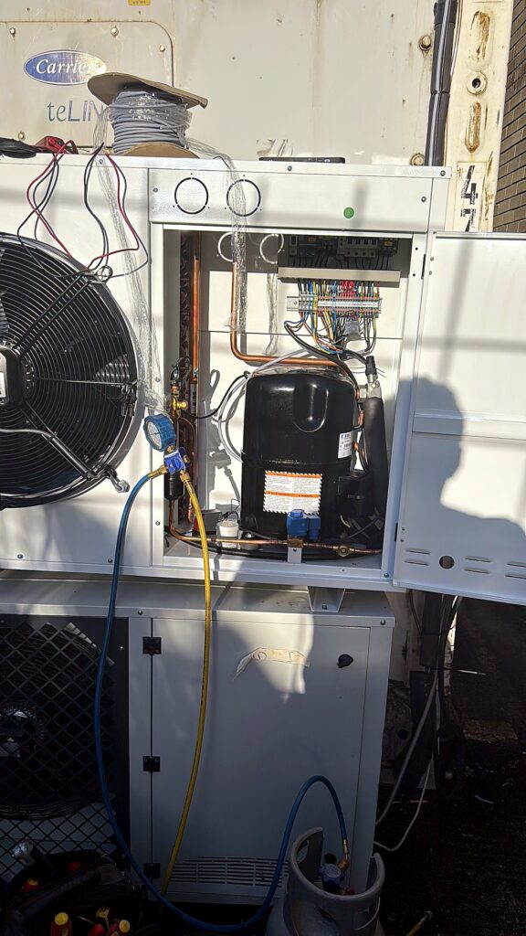 Outdoor condensing unit with fan and compressor